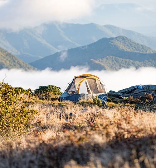 Tent set up on a mountain landscape.
